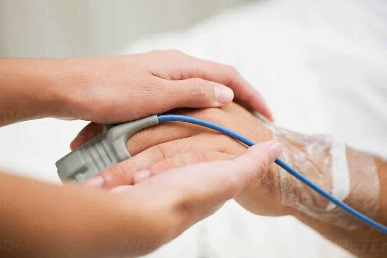 Person holding hospital patient?s hand